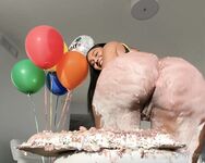 Olivia sits on my birthday cake